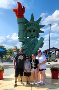 🗽

Family photo in front of the LEGO statue of Liberty.

Her tablet should say "Of course you're tired, after this amusement park you'll be Poor."