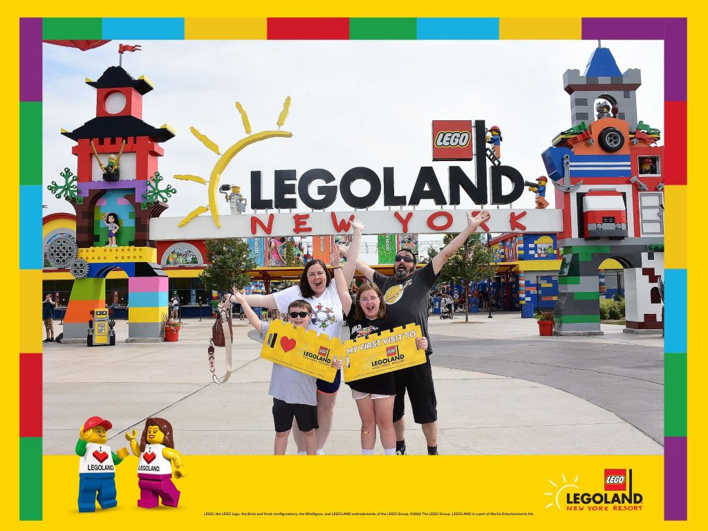 Family photo at the front sign to LEGOLAND New York.