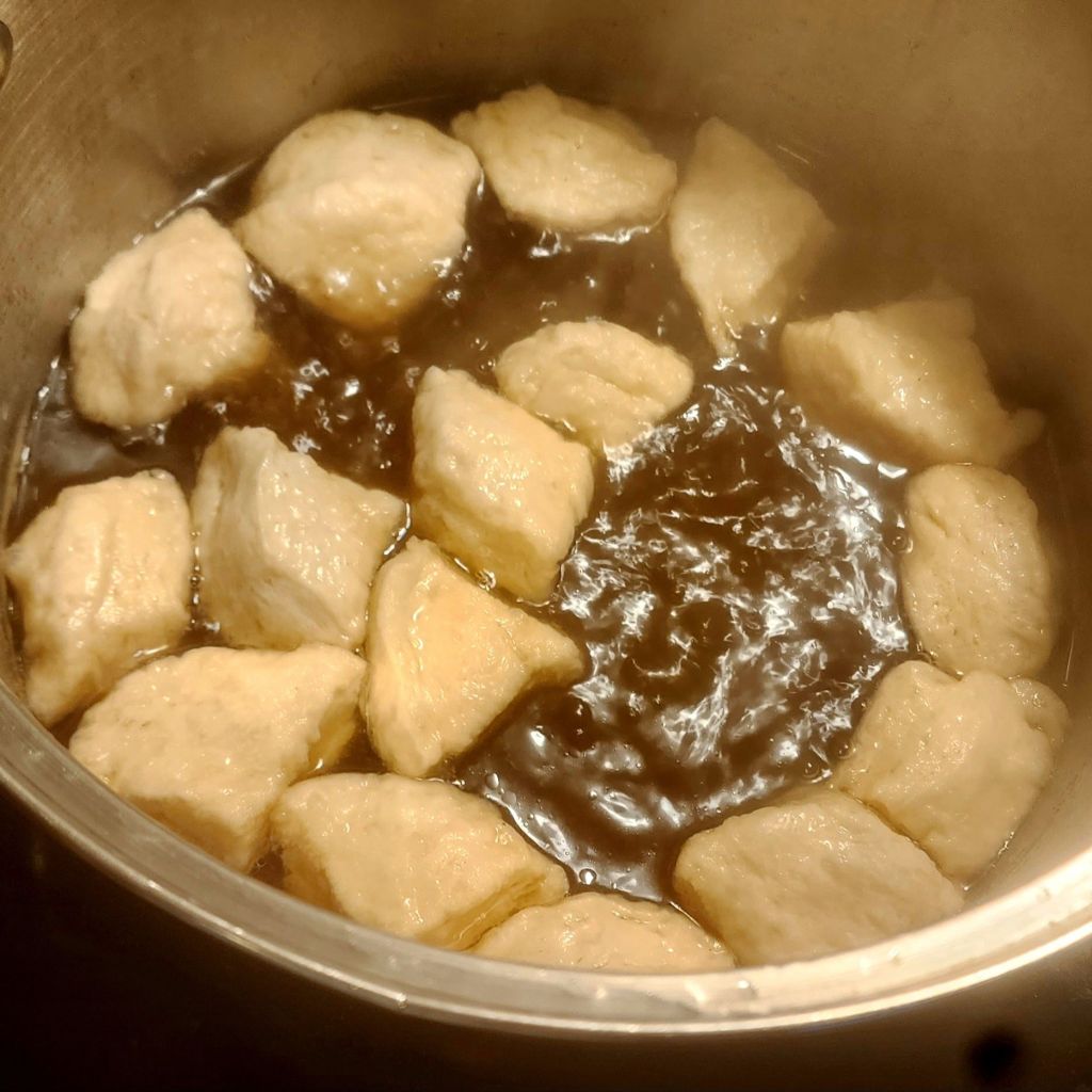 Dumplings cooking in the stock pot.