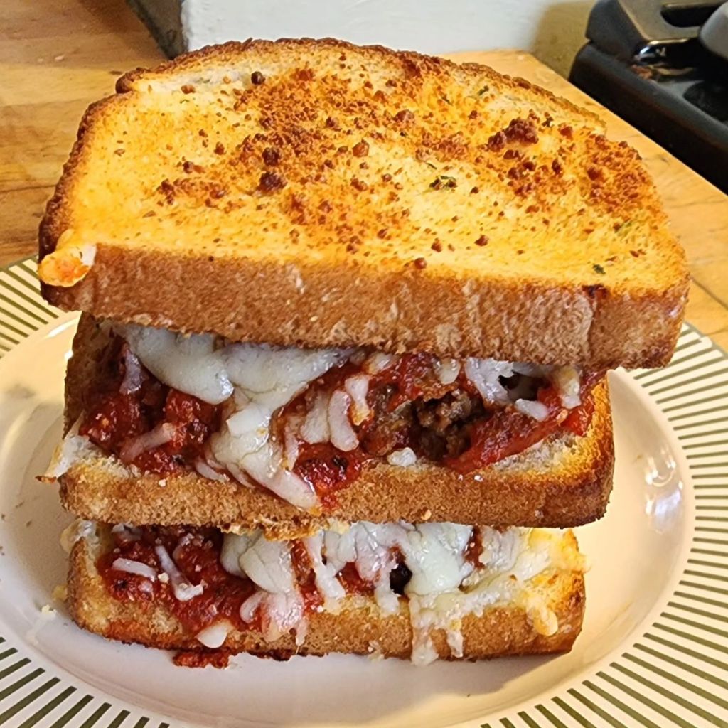 The Meatball Club:  A double-decker meatball sandwich on toasted white bread, teeming with tasty sauce & melted Gruyere and Swiss cheese.