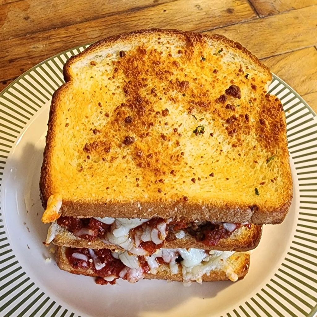 The Meatball Club:  A double-decker meatball sandwich on toasted white bread, teeming with tasty sauce & melted Gruyere and Swiss cheese.  (Slightly more from the top.)