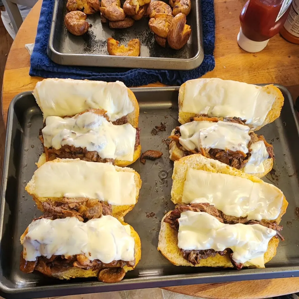 French dip sandwiches on the cooking tray.